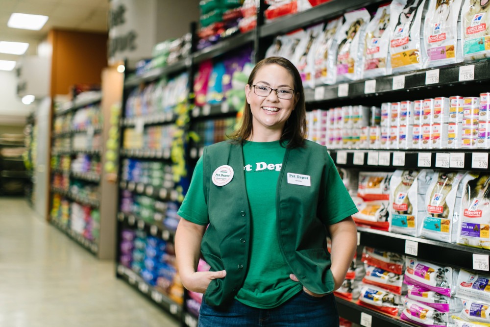 An employee on the floor of a local grocery store — the kind of place-based business Mighty Local is built for.