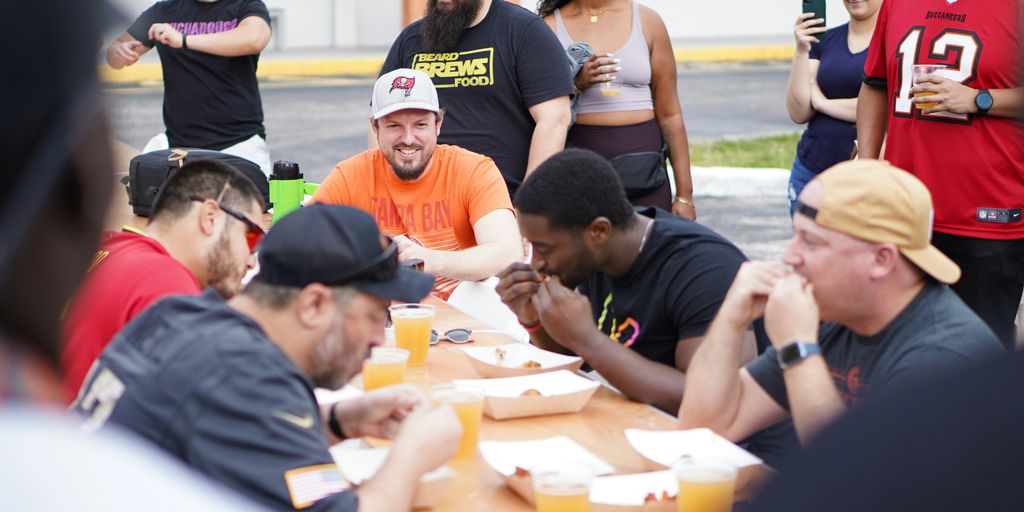 a group of people sitting around a table eating food