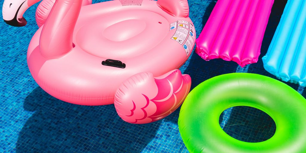 pink inflatable flamingo and green inflatable ring